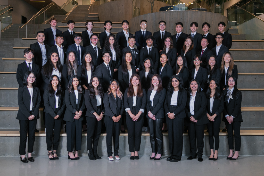 undergraduate students in business attire smiling group photo