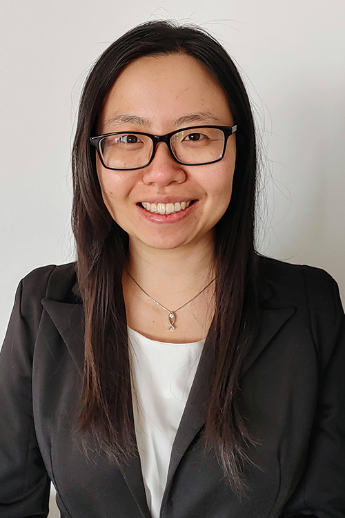 woman dark hair glasses smiling