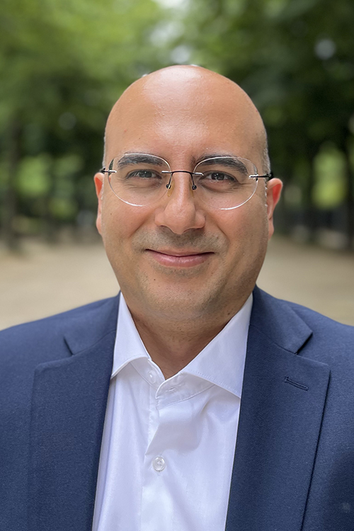 man glasses business attire smiling