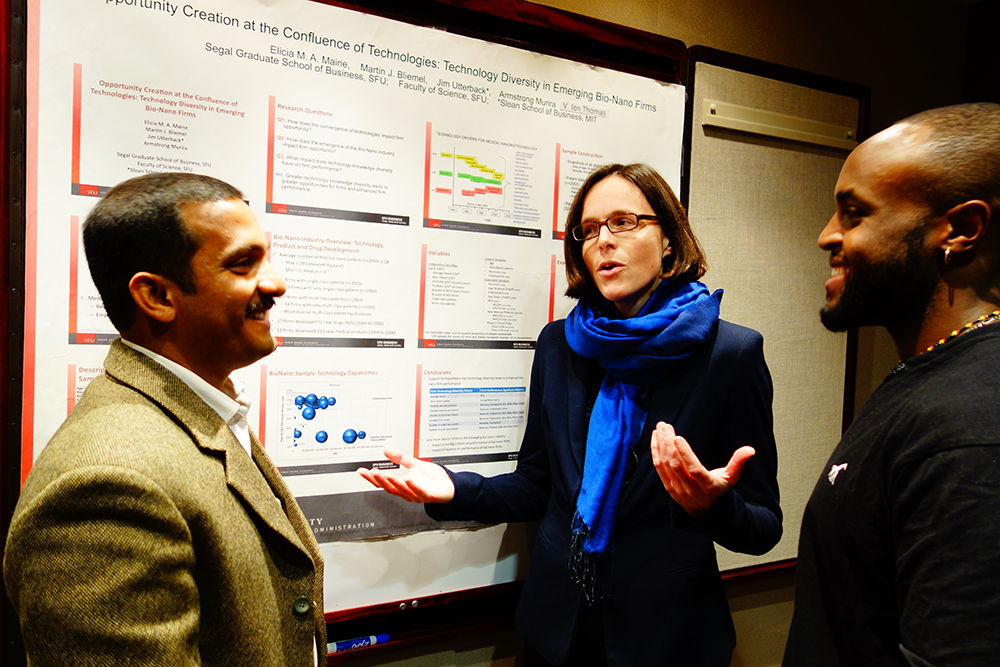 Elicia Maine, Academic Director of the Management of Technology MBA program discussing bio nano research with collaborators V.J. Thomas and Armstrong Murira. Photo credit: Barry Shell