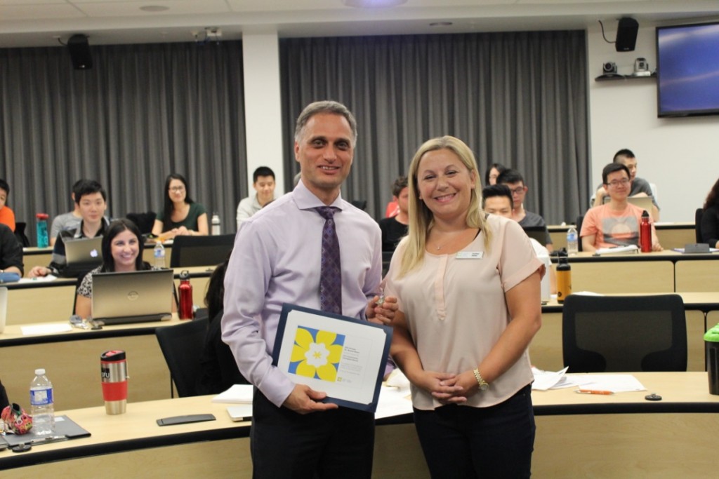 Beedie School of Business lecturer Kamal Masri was presented with the Community Champion Award in front of his BUS 361 class by Carissa Halley, Team Lead, Annual Giving at the Canadian Cancer Society. 