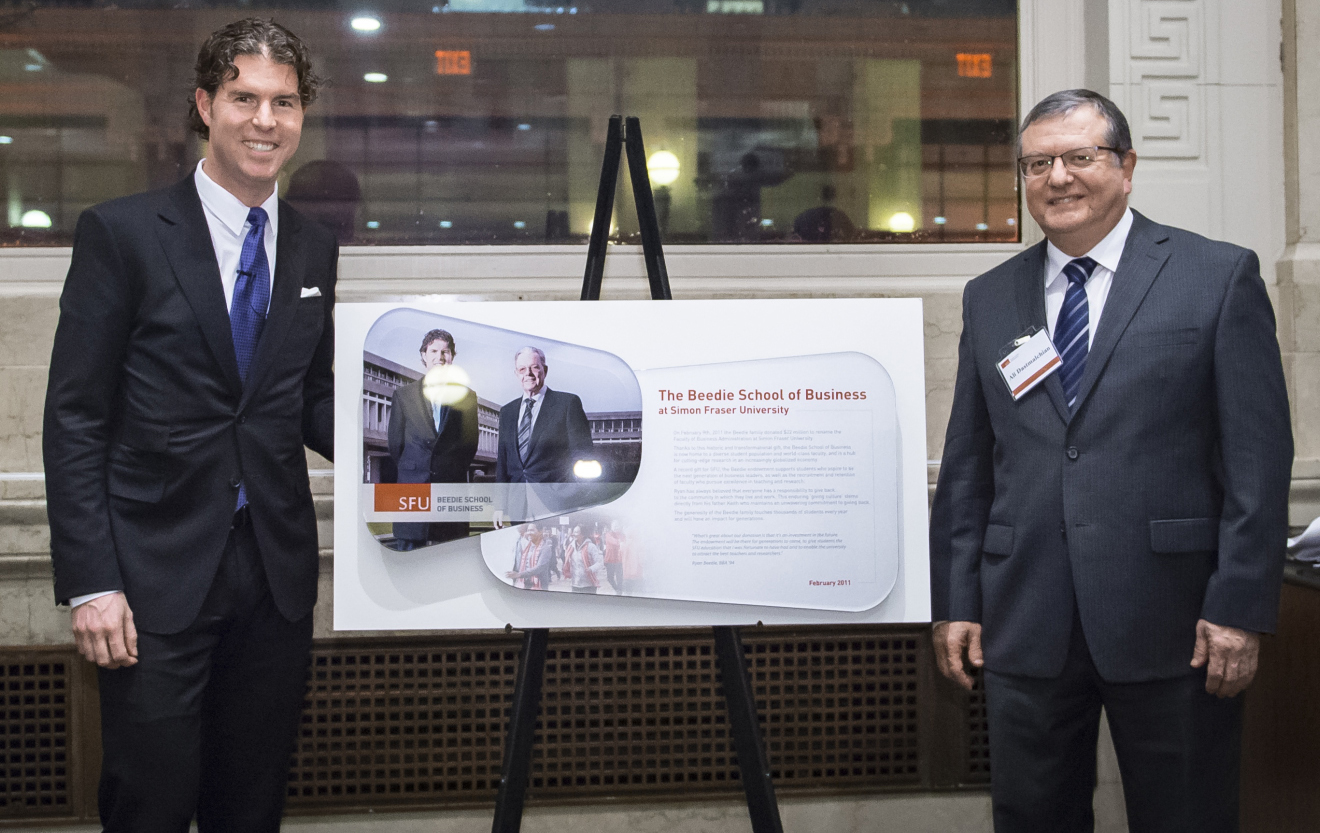 Ali Dastmalchian, Dean of the Beedie School of Busines (right) presented Ryan Beedie (left) with a plaque marking five successful years since his historic gift. 
